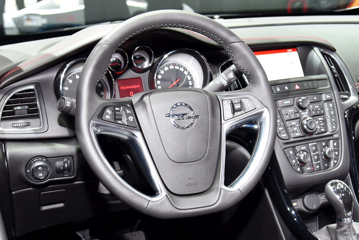Steering wheel with integrated controls and instrument cluster in car interior