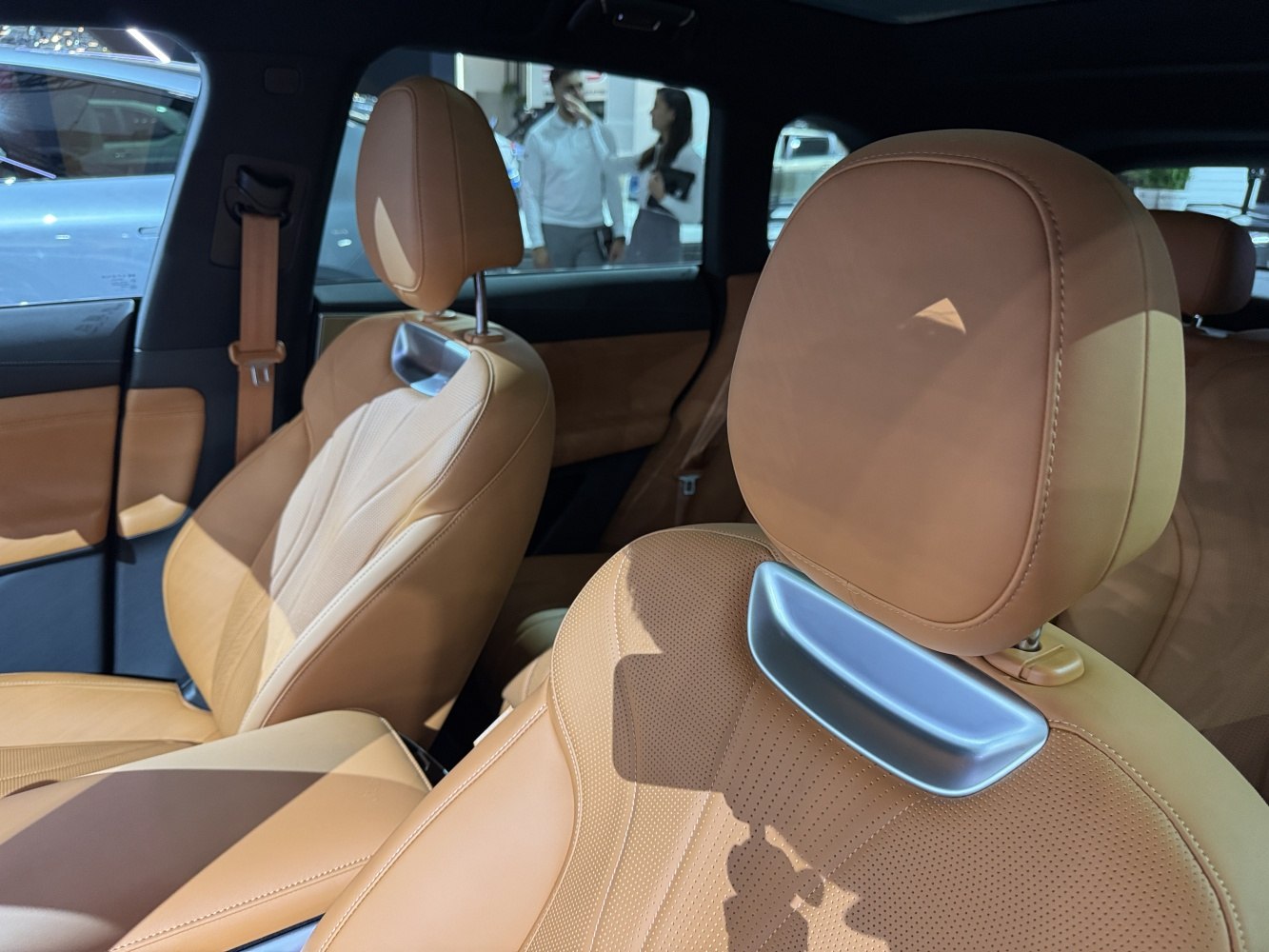 Brown leather seats with perforations and modern headrest design