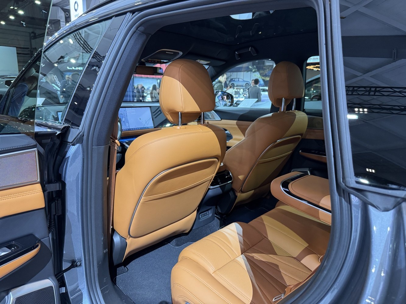 Rear interior luxury with tan leather seats and advanced cabin design