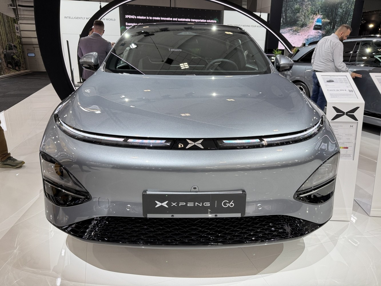 Front view of an electric SUV with sleek headlights and modern grille design