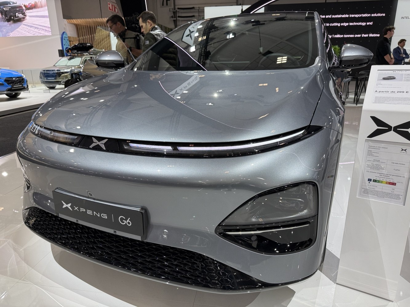 Sleek LED headlights and honeycomb grille in modern electric SUV front design.