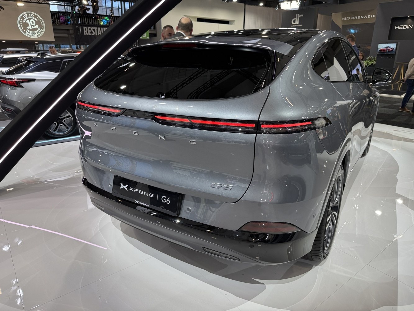 Rear view with continuous LED tail light strip and aerodynamic hatchback design.