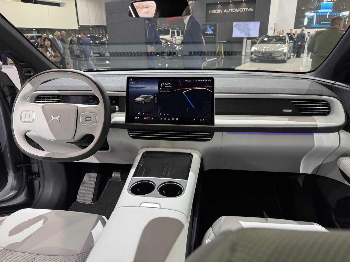 Digital dashboard with central touchscreen and modern steering wheel.