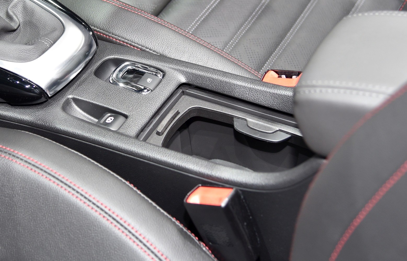 Close-up of center console with electronic handbrake and armrest storage