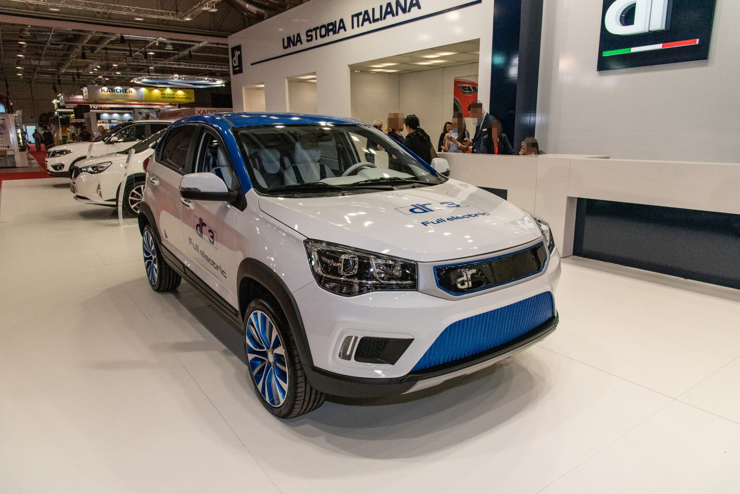 Front and side view of a full electric compact SUV with blue grille and wheels