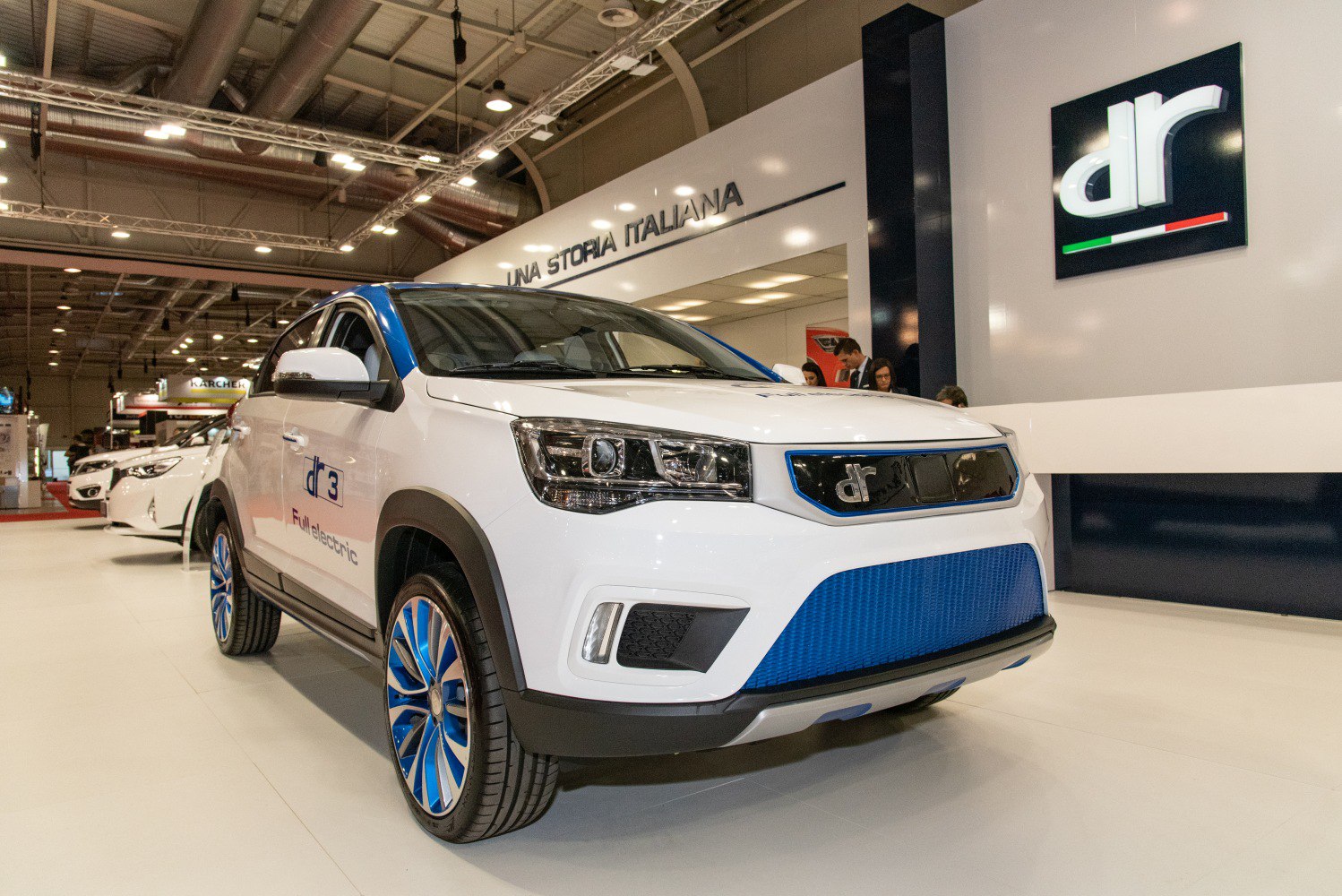 White electric SUV with blue grille and rims, modern headlights