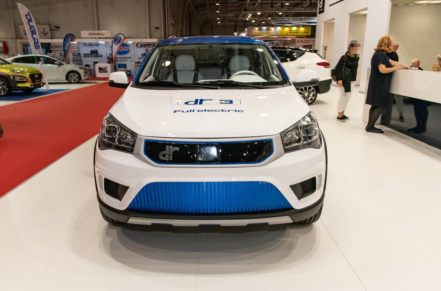 Front view of electric vehicle with distinctive grille and headlights