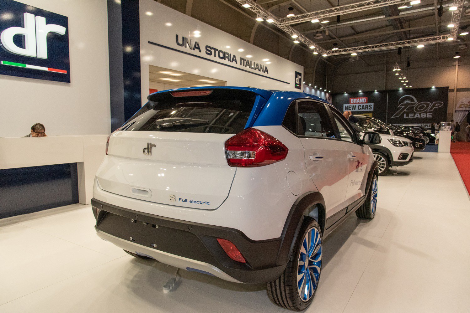 Rear view of electric compact SUV with blue-accented alloy wheels and distinctive taillights