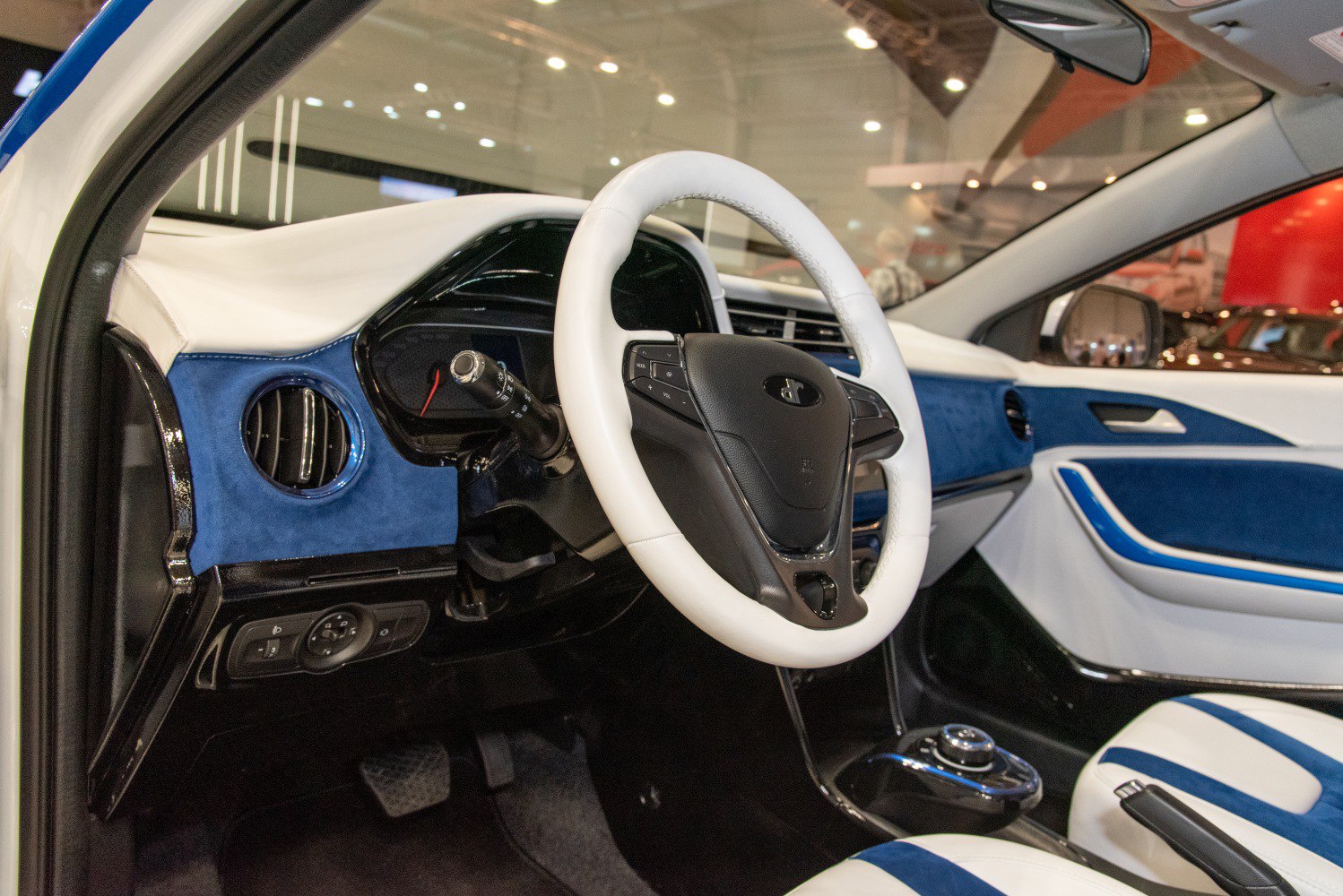 Blue and white steering wheel and dashboard interior design.