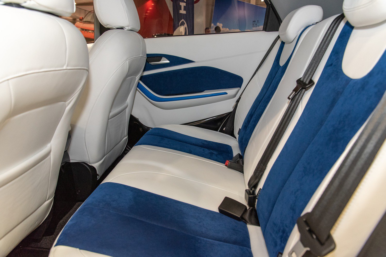 Blue and white upholstered rear seats with seat belts