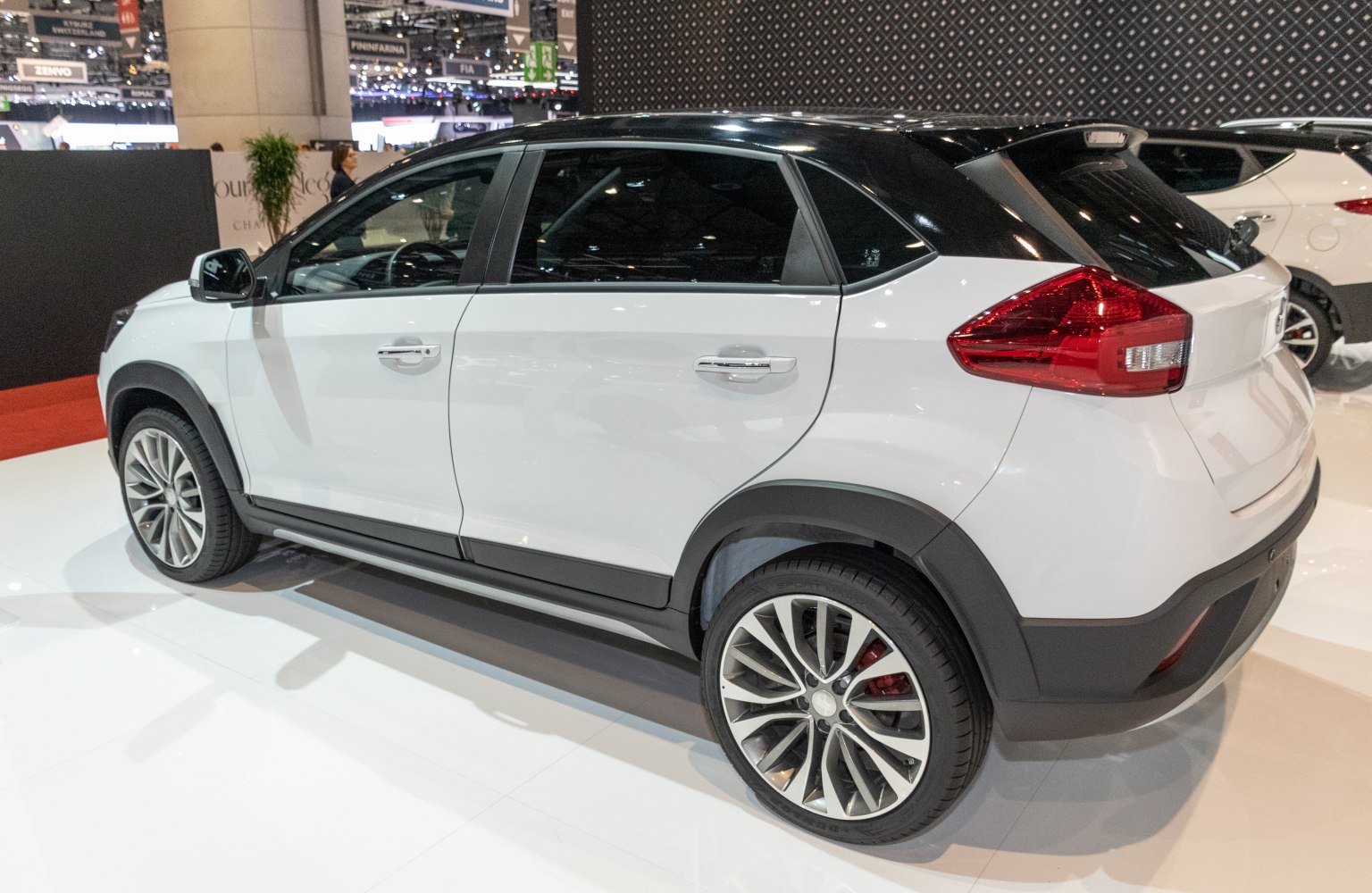 White compact crossover SUV with black roof and multi-spoke alloy wheels