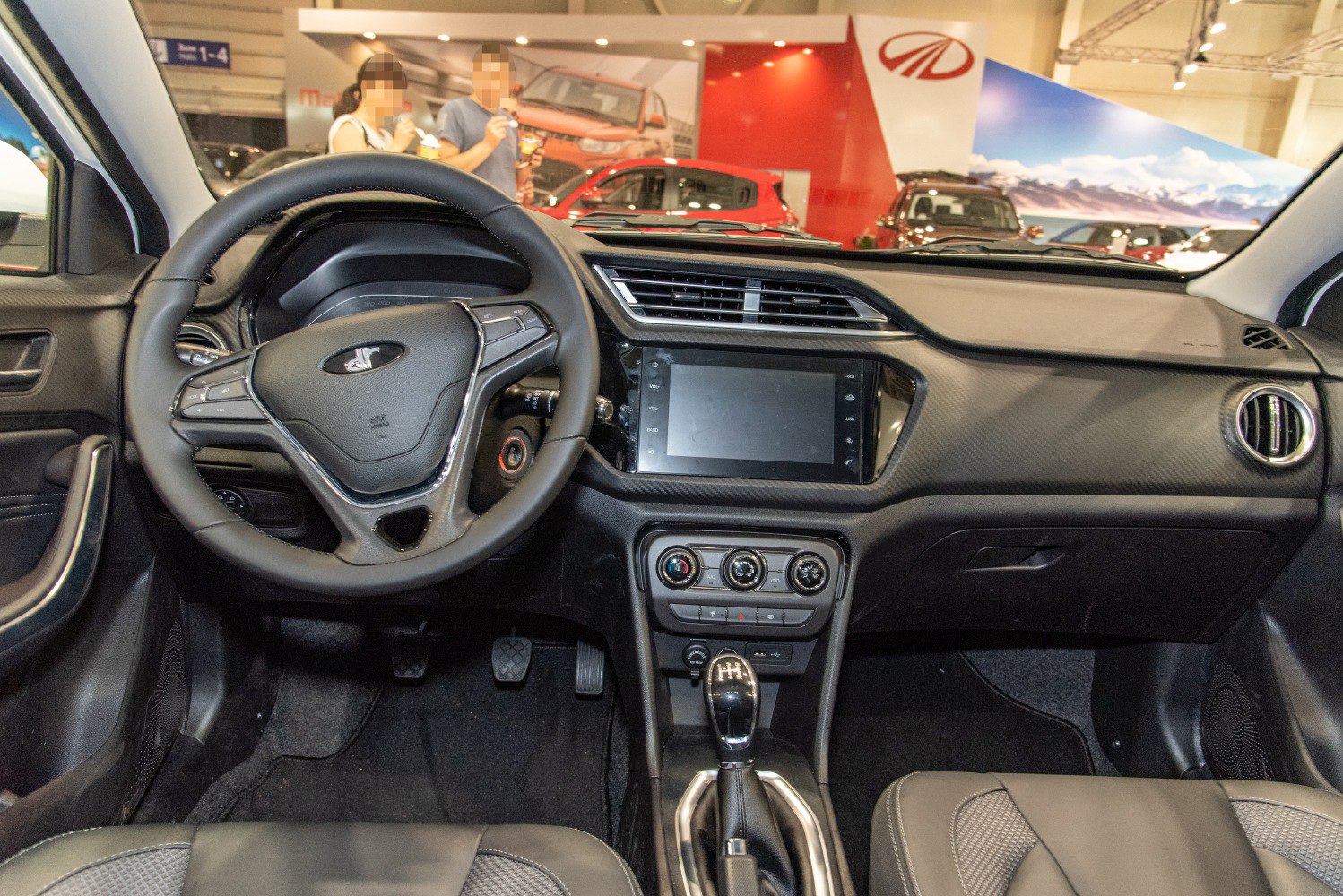 Multifunction steering wheel and infotainment touchscreen in car interior
