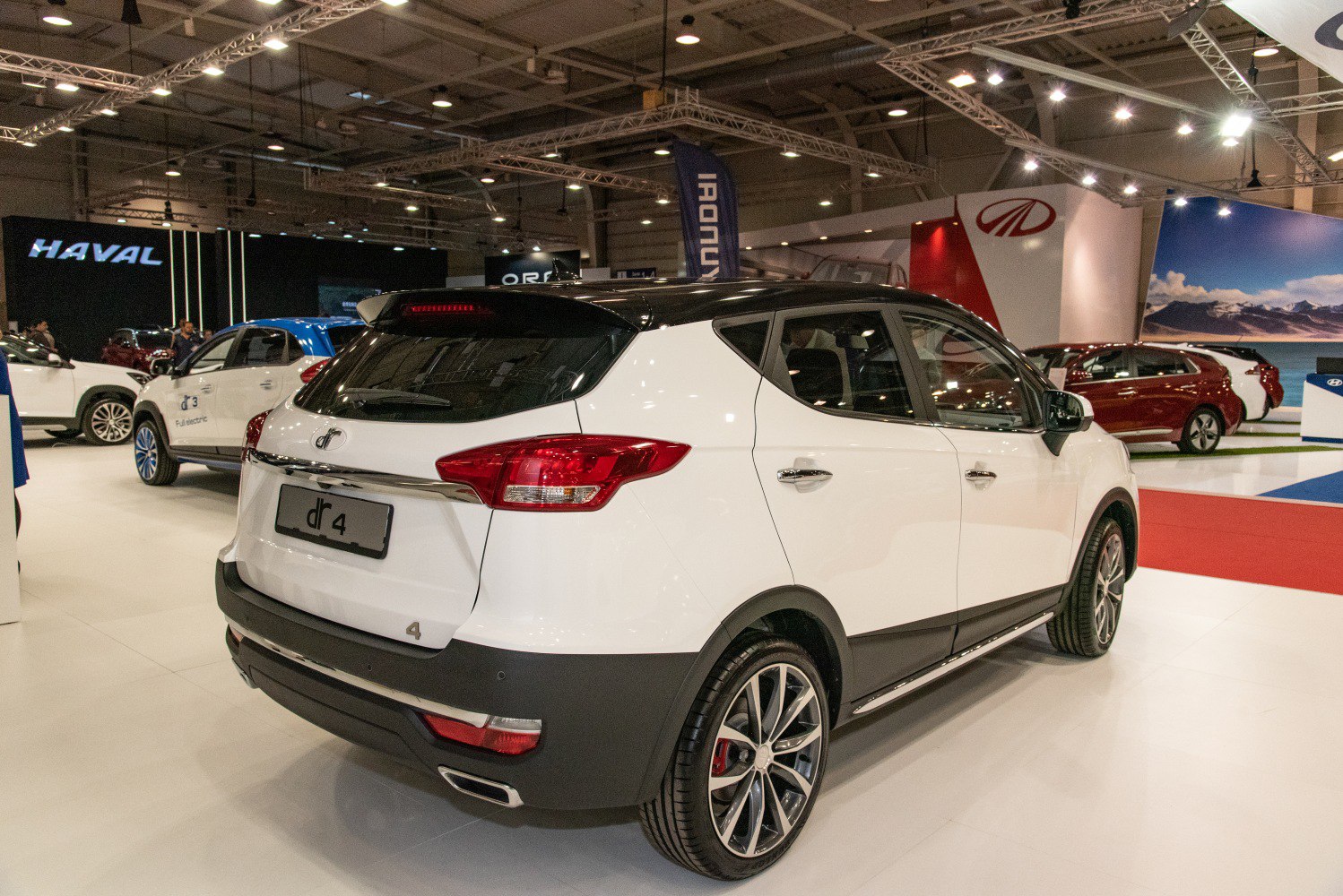 Rear view of two-tone crossover SUV with sporty alloy wheels and modern taillights