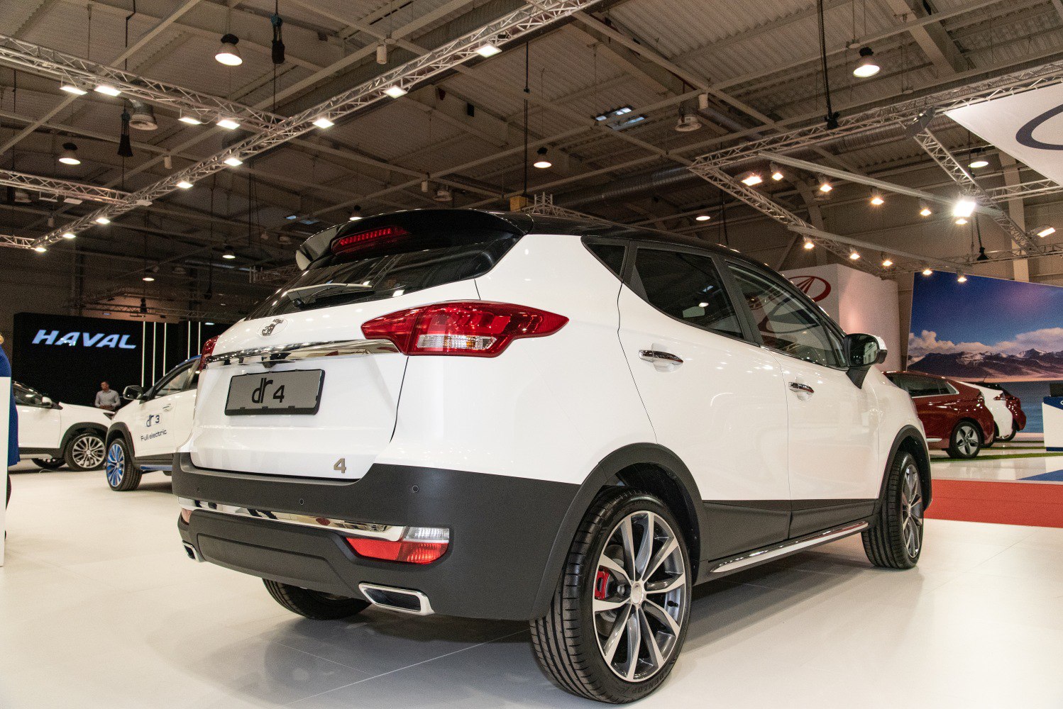 Rear and side profile of white compact SUV with alloy wheels