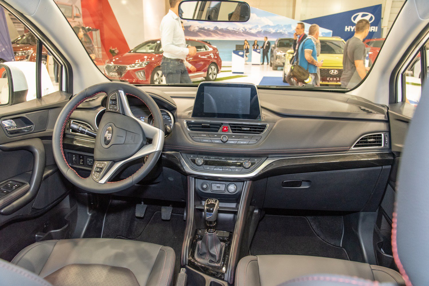 Modern car interior with digital display and manual gear shift