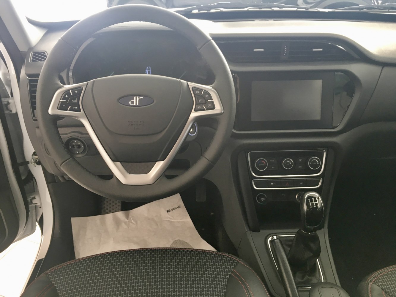 Steering wheel with controls and manual gear shift in car interior