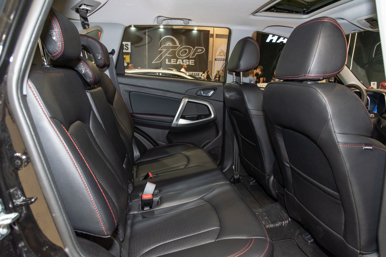 Black leather rear seats with red stitching and spacious cabin design