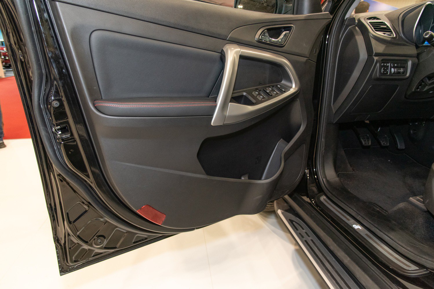 Car interior door panel with window and mirror controls