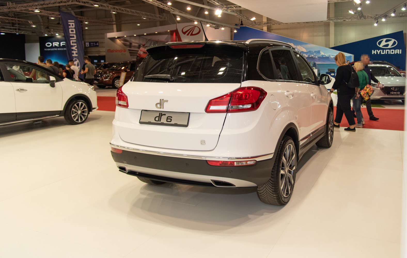 Rear of white SUV with dual exhaust and prominent taillights