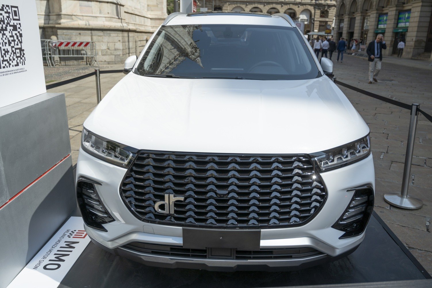 Wide bold grille with repeating wave pattern and integrated LED headlights