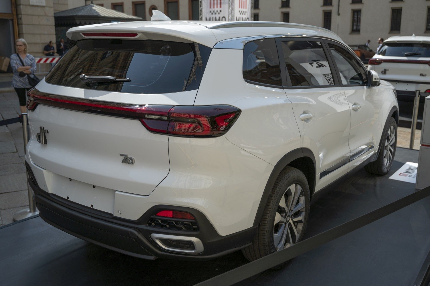 Rear and side profile of a white SUV with sleek taillights and alloy wheels