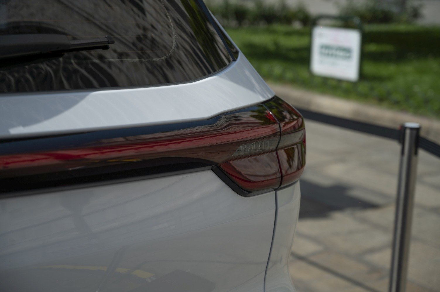 Close-up of rear tail light and rear window wiper on white vehicle
