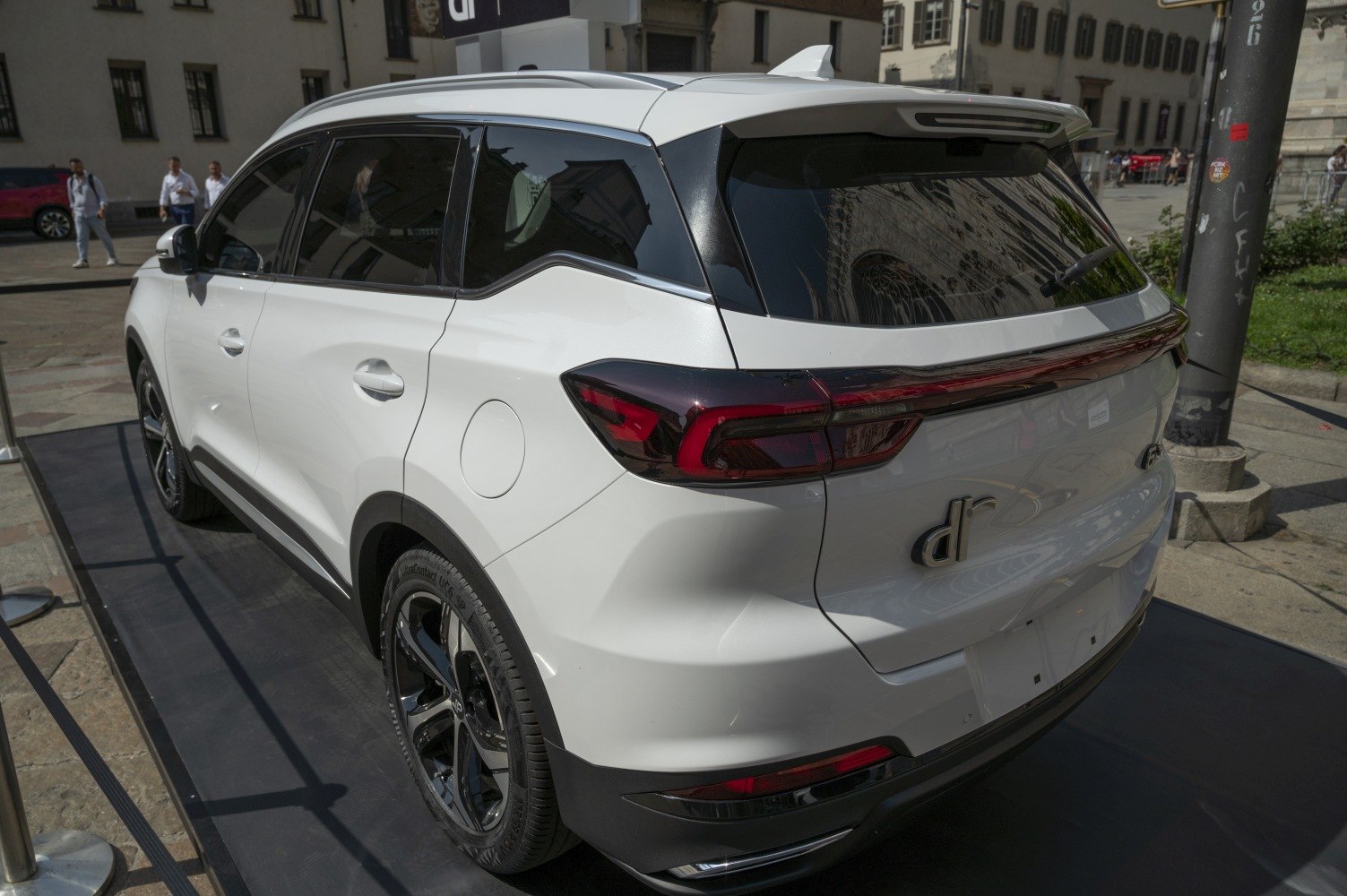 Rear and side view of white SUV with dark tinted windows and modern tail lights