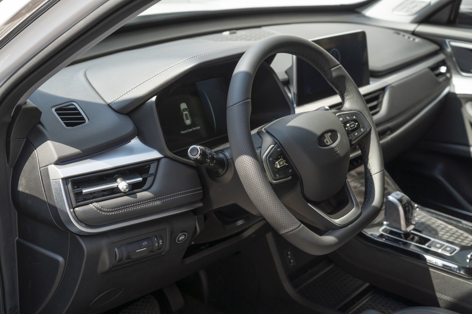 Steering wheel with control buttons and digital dashboard display