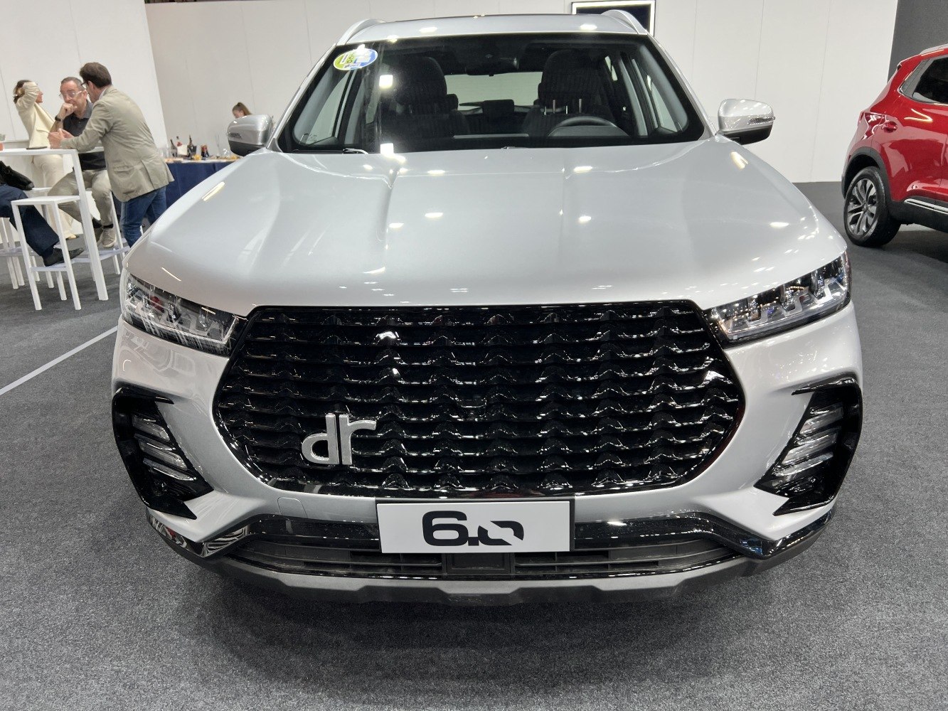 Large black grille and modern headlamps of an SUV front