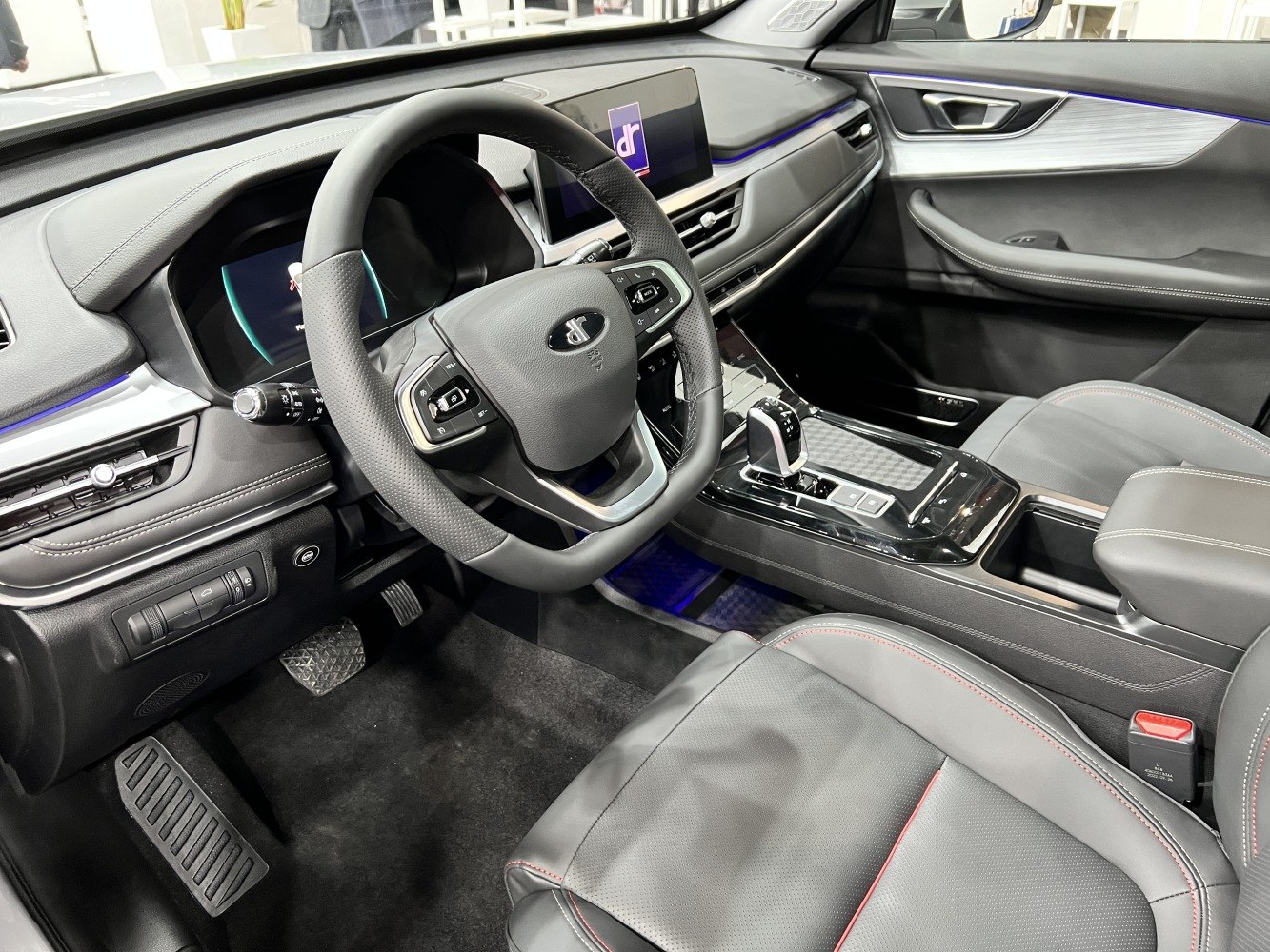 Steering wheel and digital dashboard with modern center console and ambient lighting