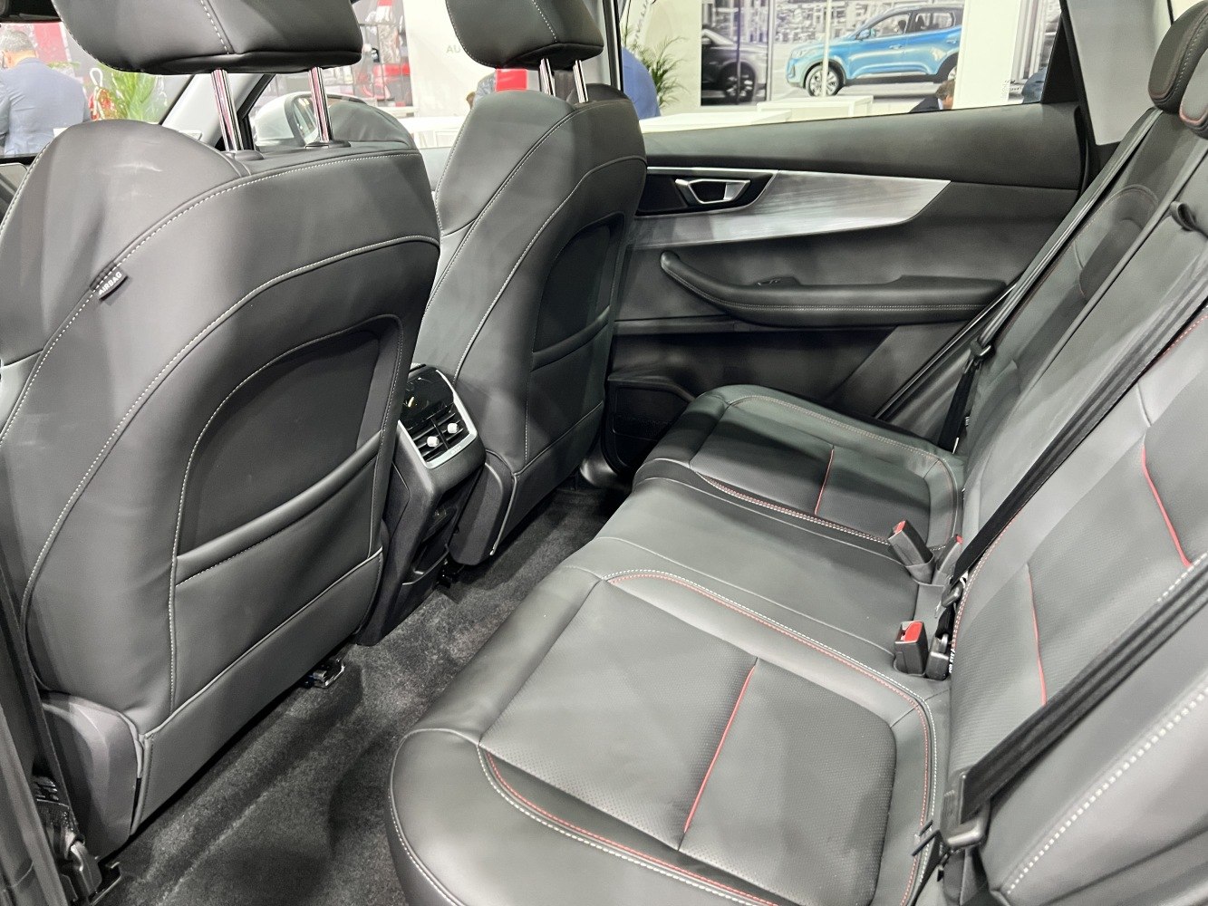 Spacious rear leather seats with red stitching and rear climate controls