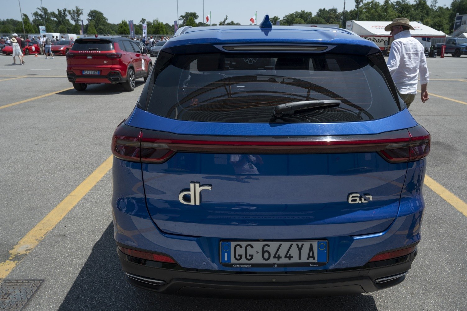 Modern SUV rear with horizontal taillights and rear window wiper.