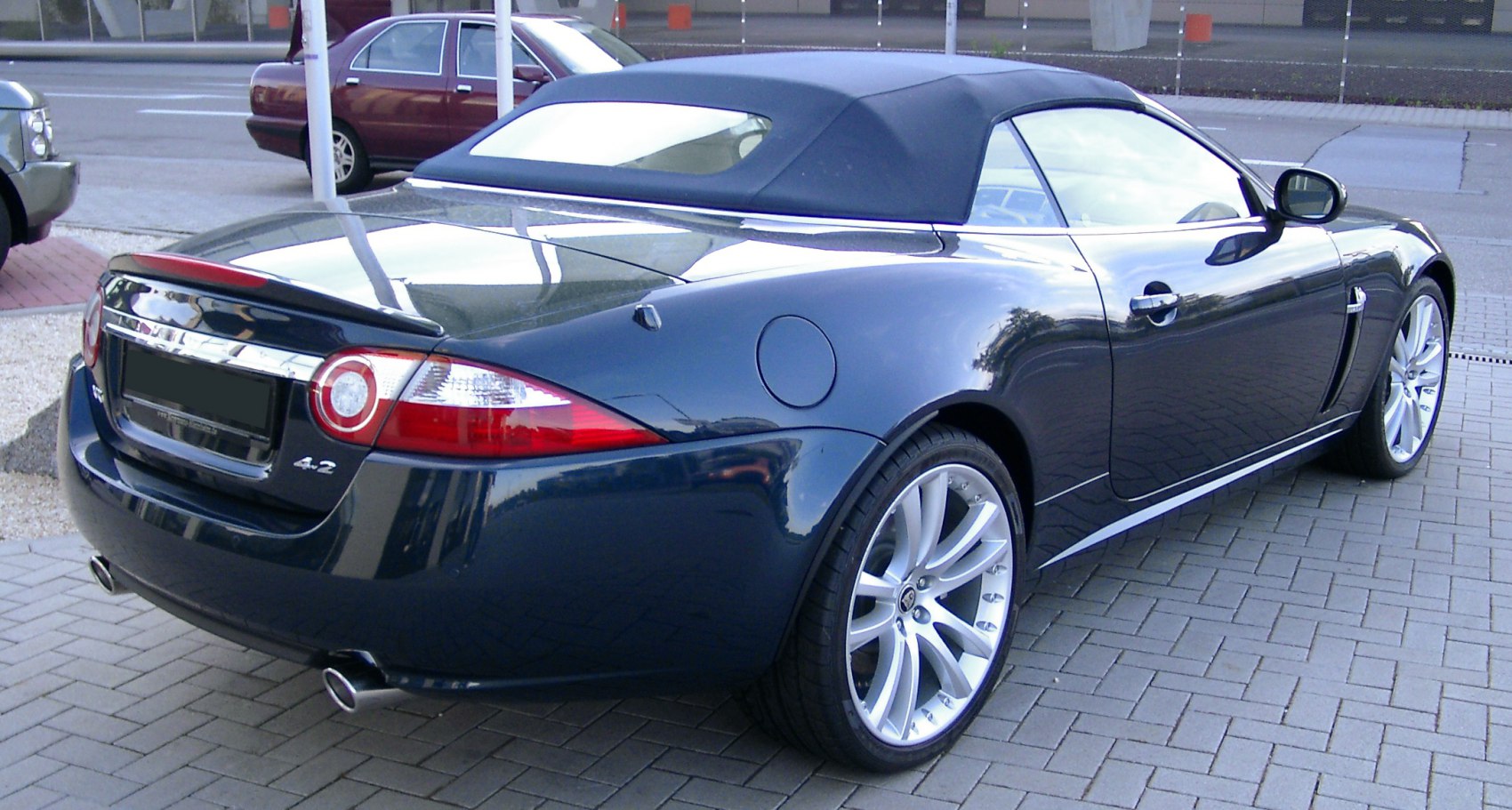 Rear view of convertible with soft top and alloy wheels
