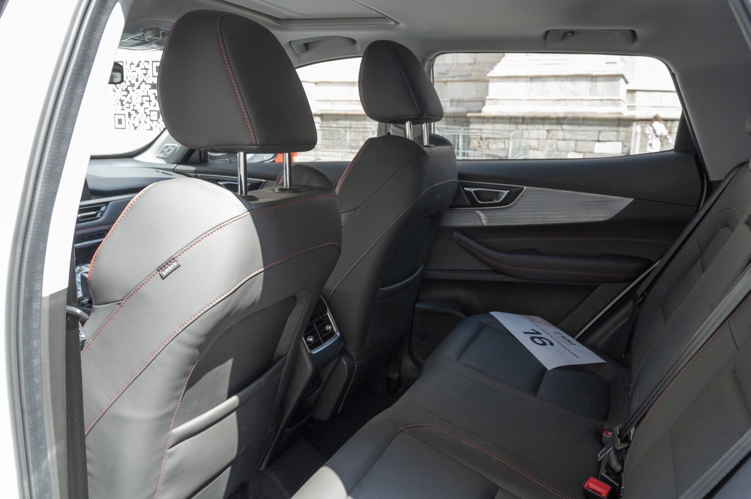Spacious rear passenger seating with leather upholstery and modern car door panel