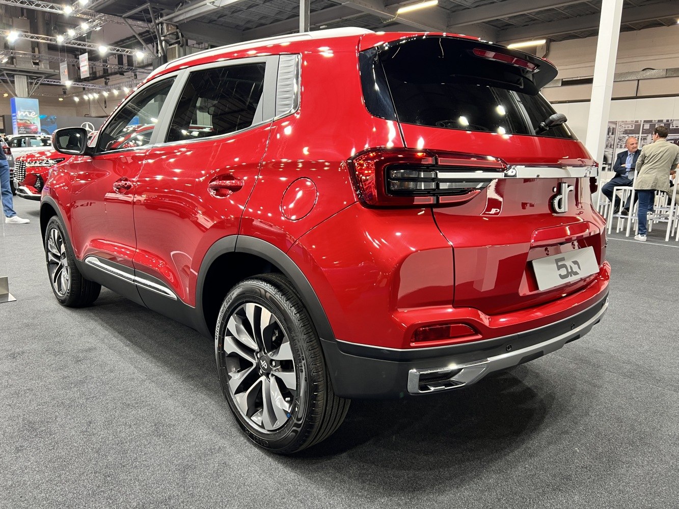 Rear and side profile of red SUV with modern tail lights and alloy wheels