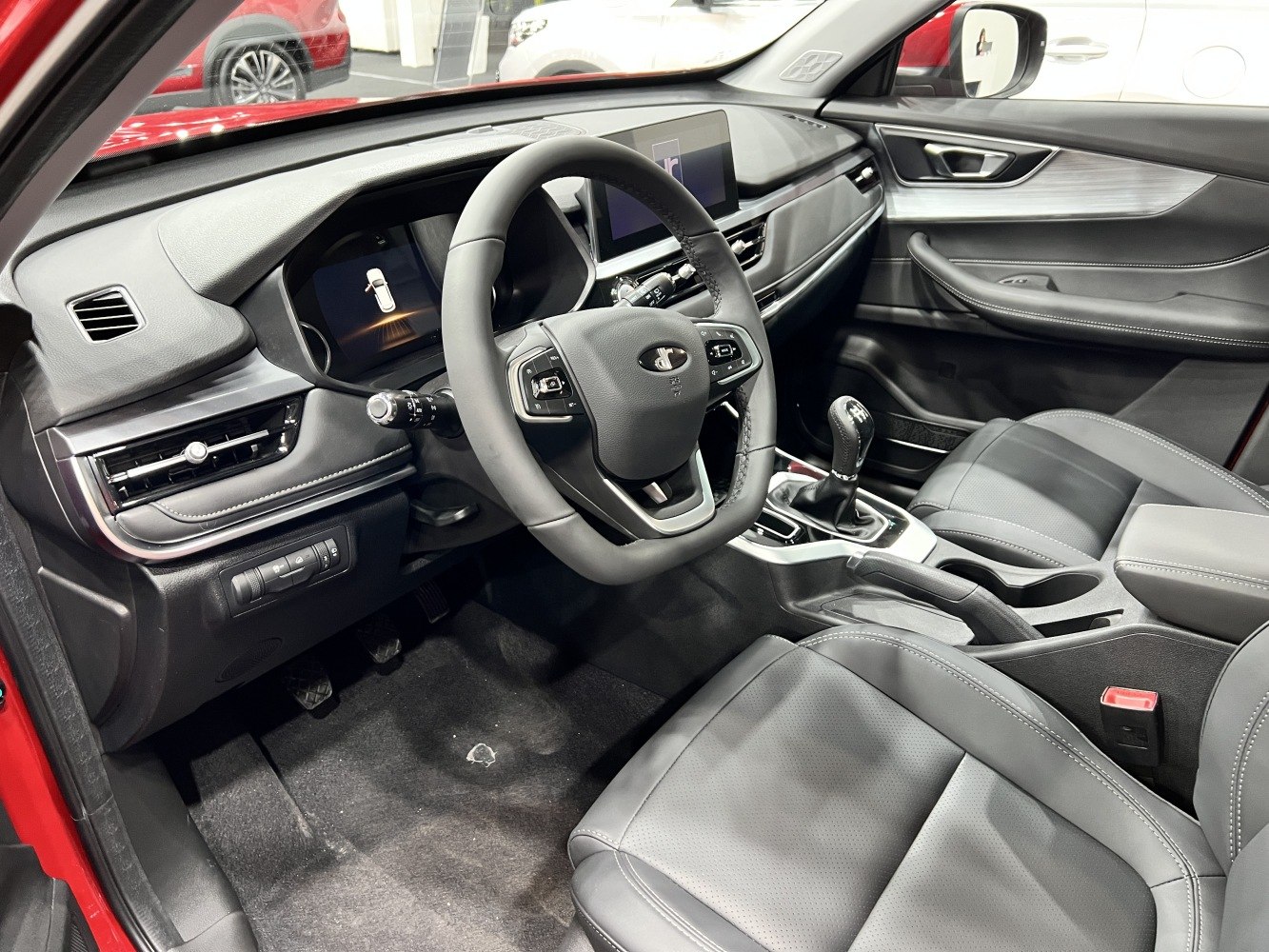 Modern car interior with digital displays and manual gear shift