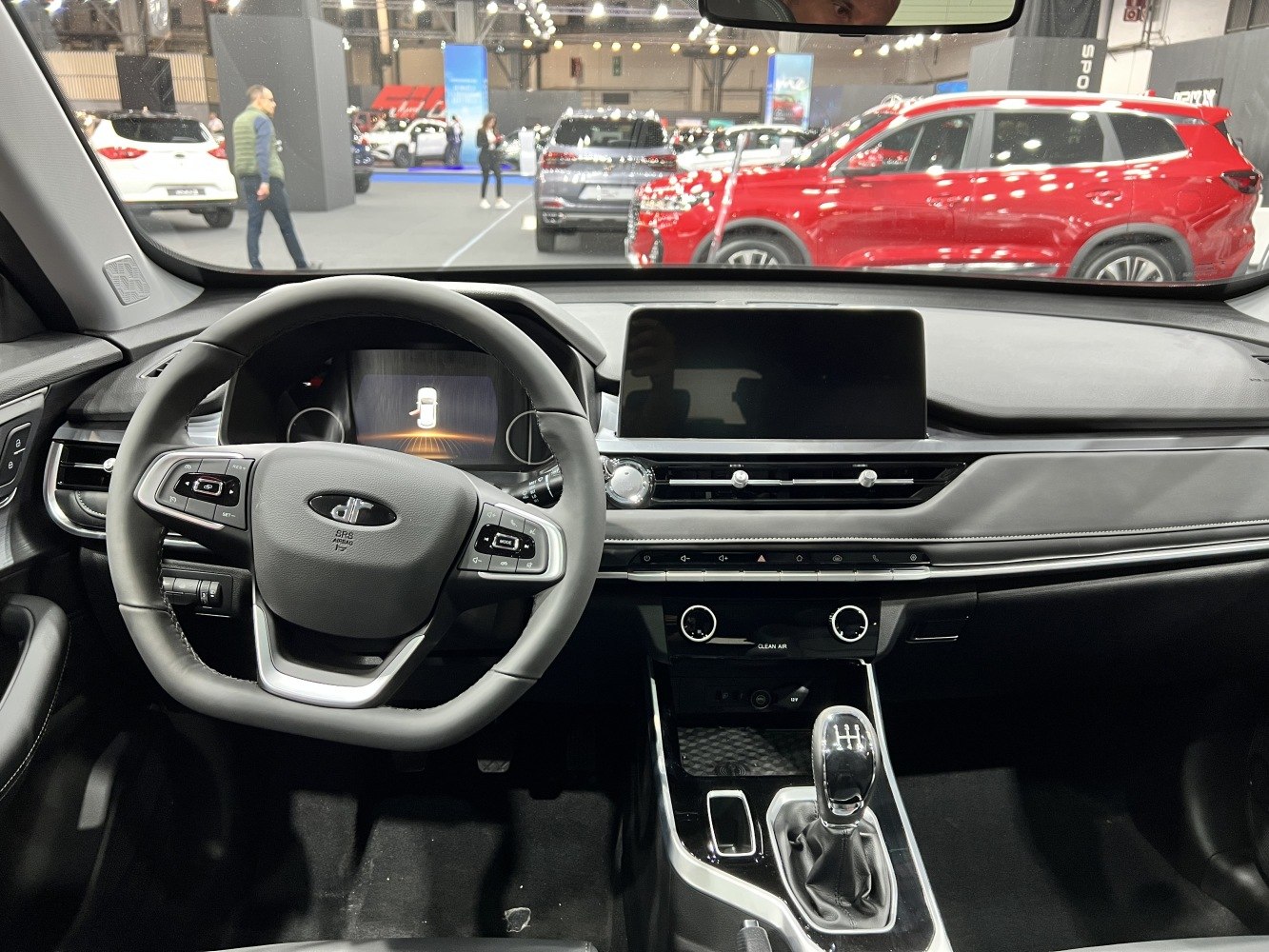 Digital dashboard and manual transmission gear stick in modern car interior