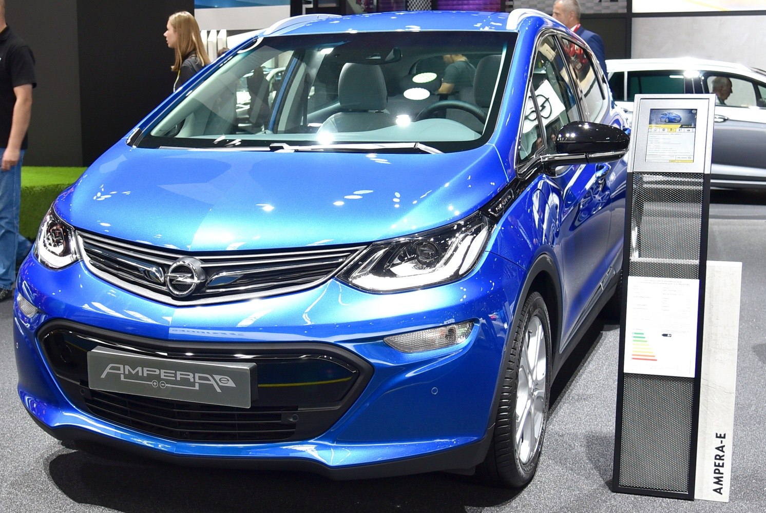 Blue electric hatchback front-side view at auto show