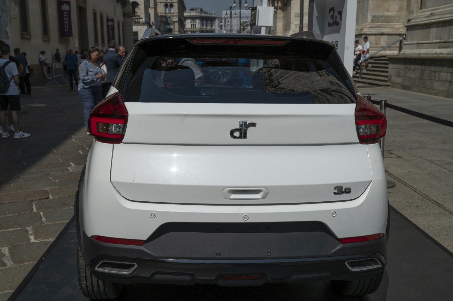 Rear view of white compact SUV with distinctive taillights and dual exhaust outlets.