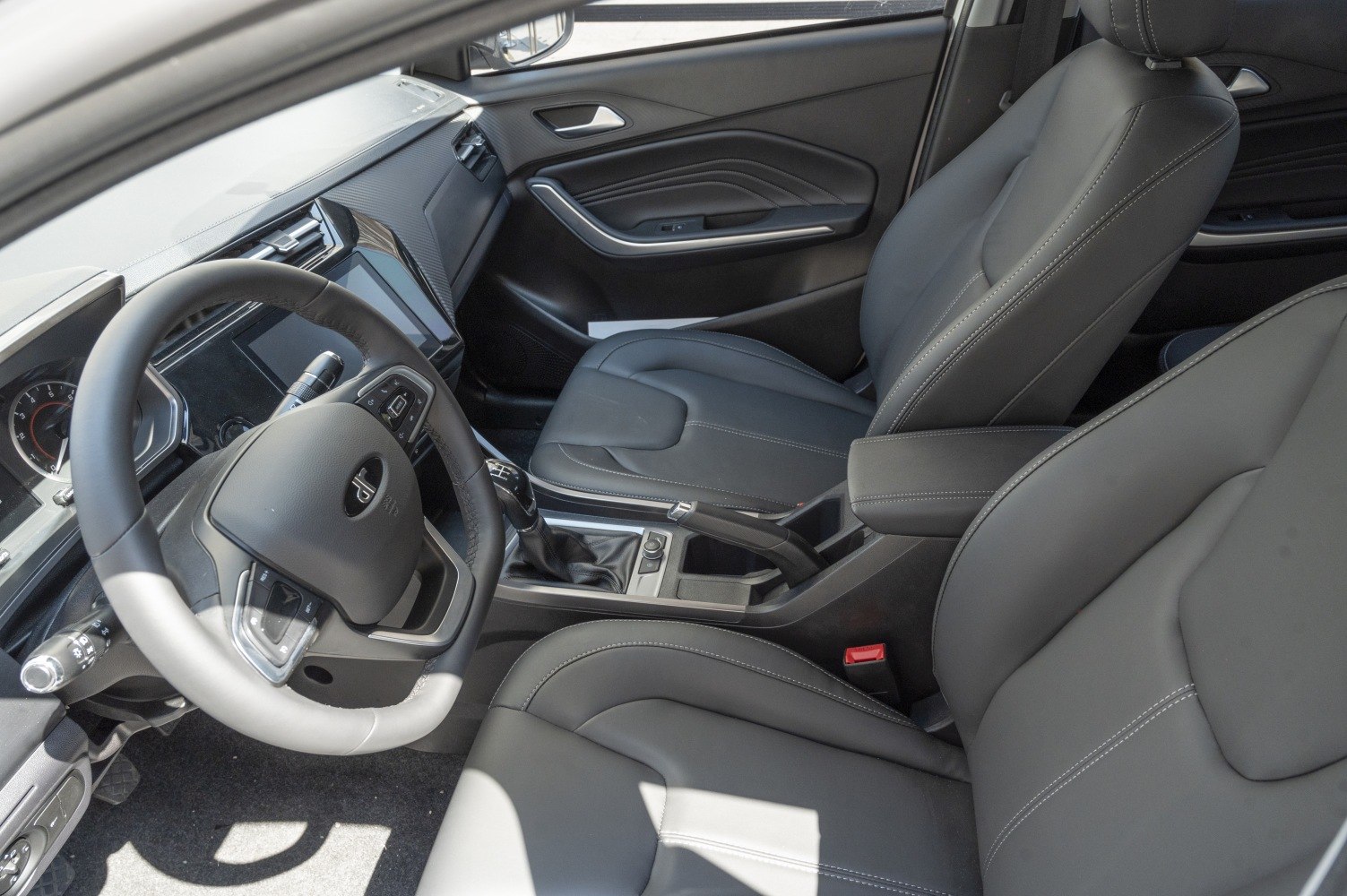Leather seats and modern dashboard with manual gearshift