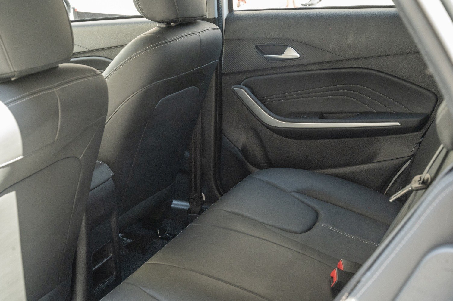 Rear seat and door panel with black leather upholstery and modern design