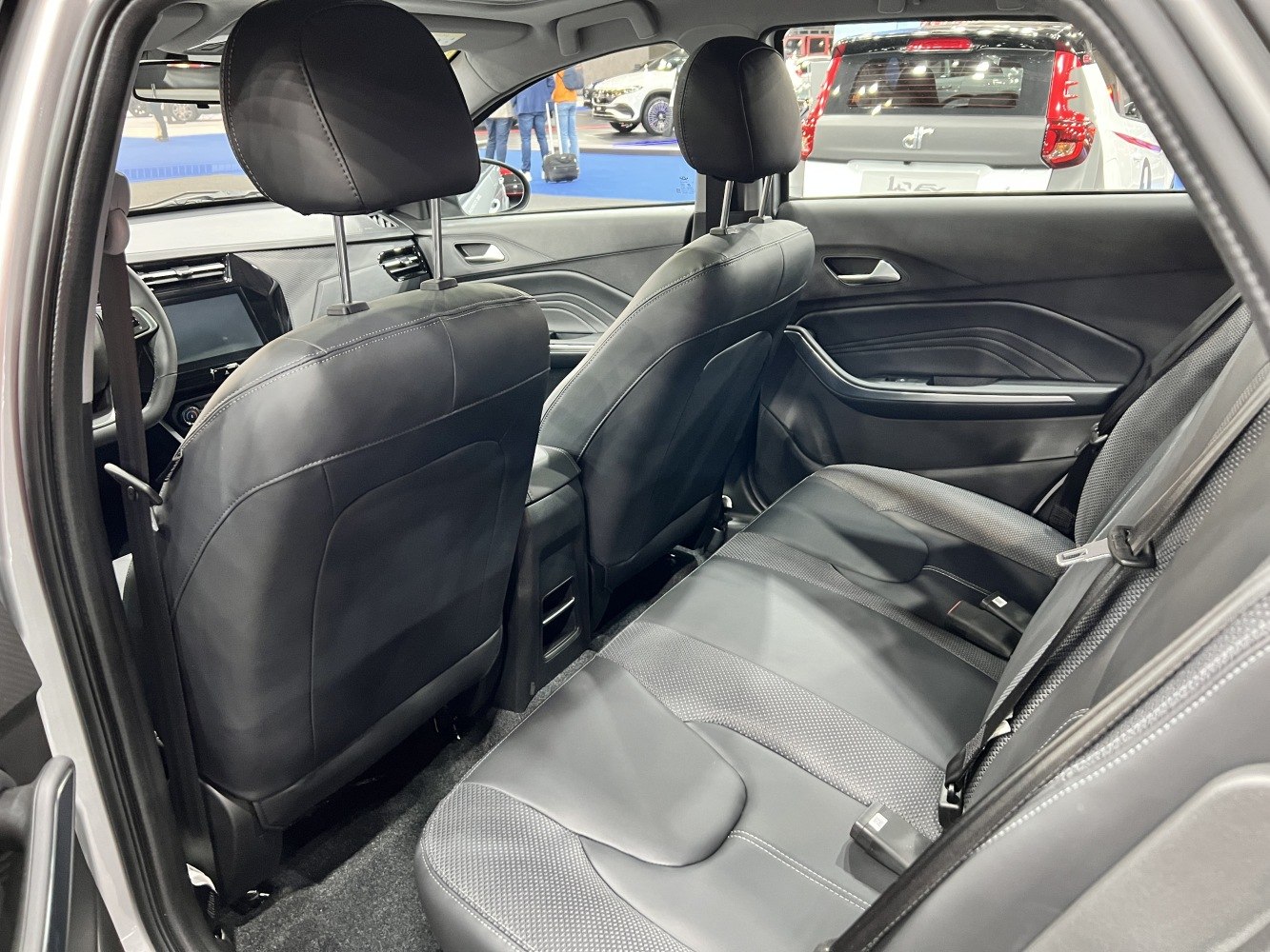 Spacious rear seating with black upholstery and modern interior design