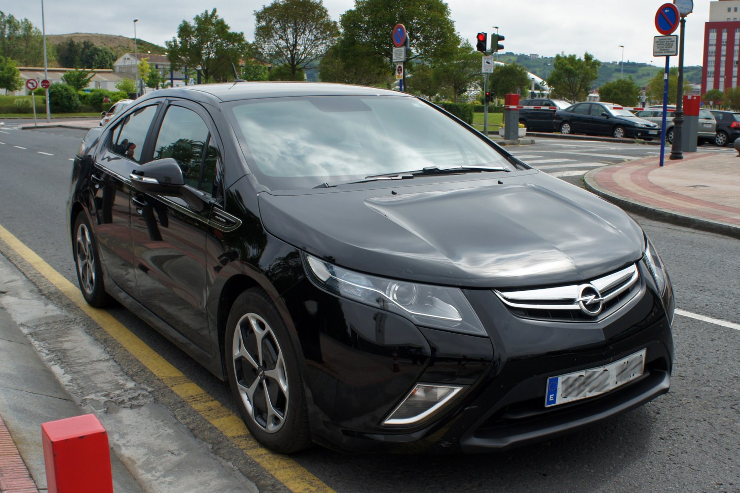 Front and side view with sleek headlights and alloy wheels