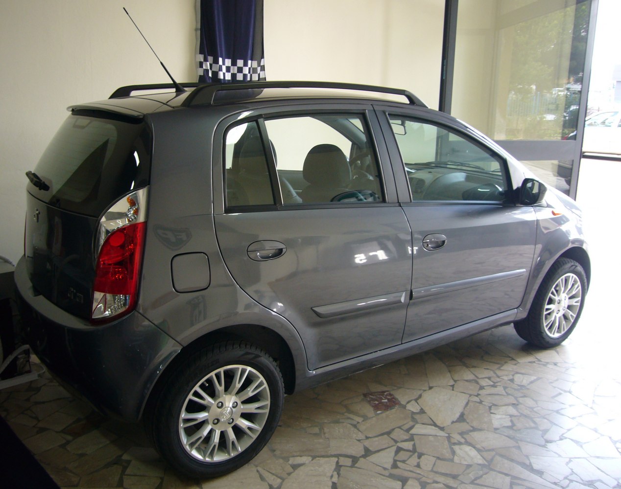 Compact hatchback with roof rails and alloy wheels