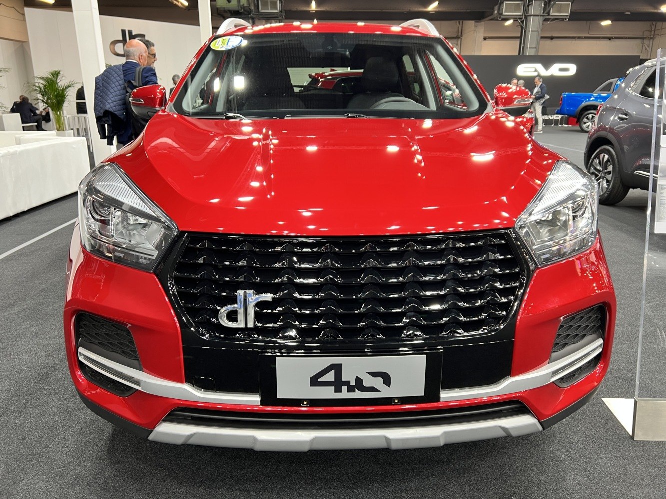 Bold front grille and sharp LED headlights of red SUV