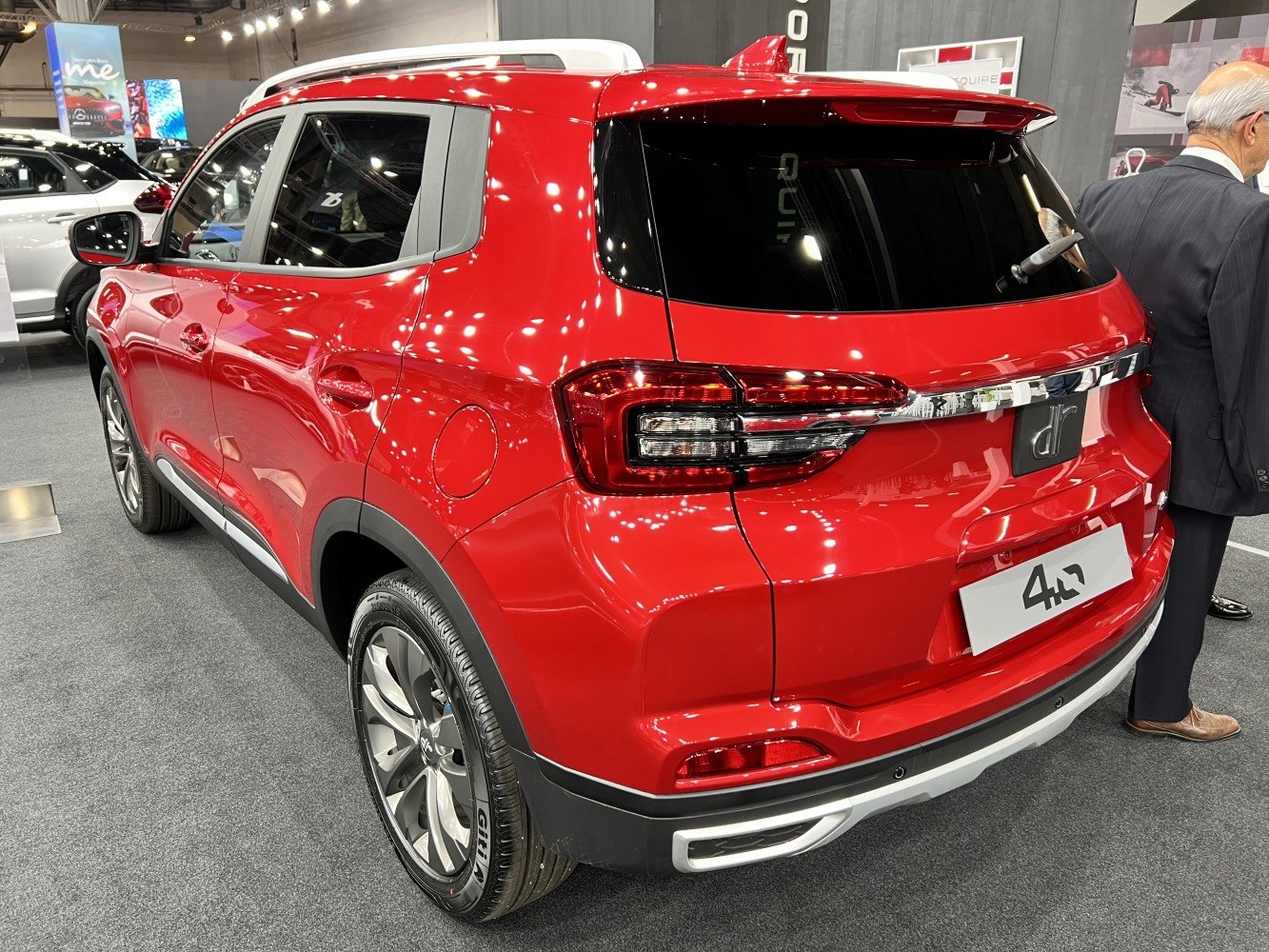 Red SUV rear view with sleek taillights and roof spoiler