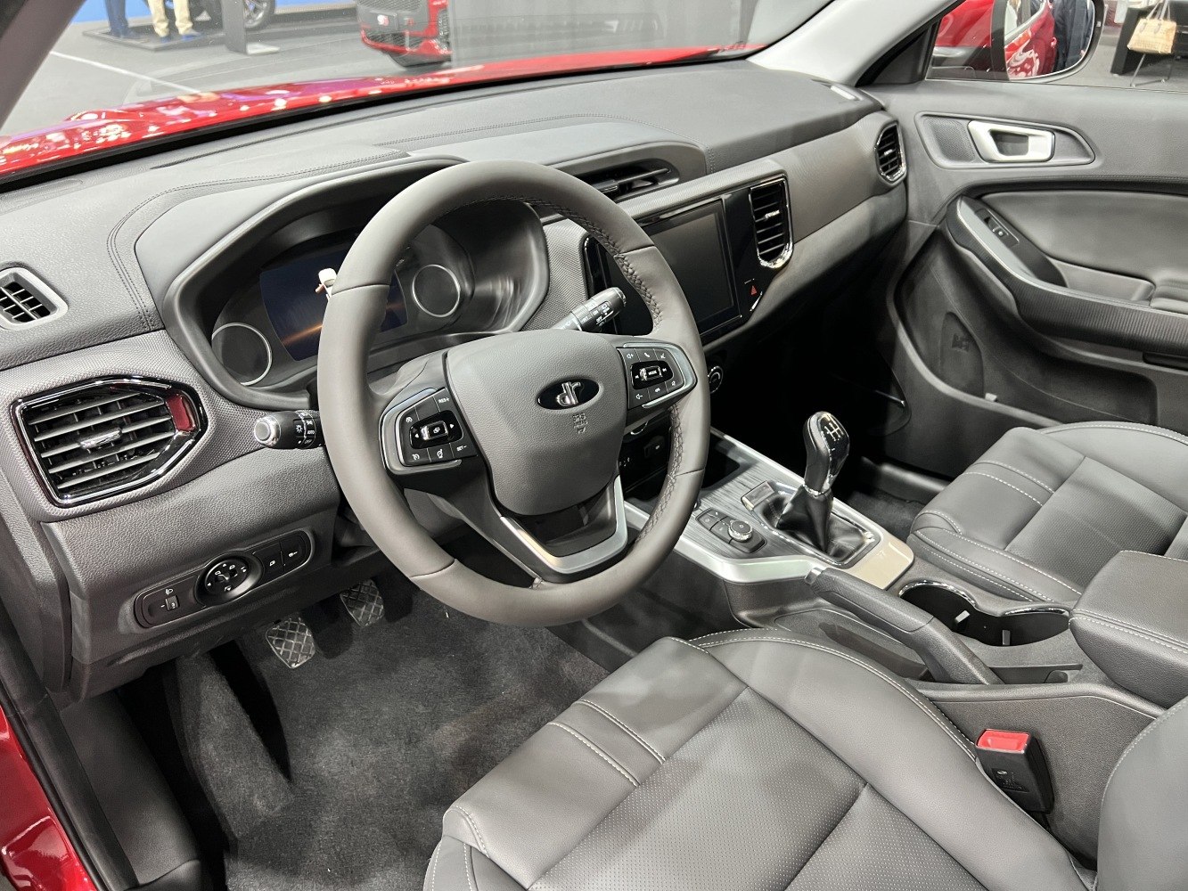 Modern car interior with steering wheel and manual gear shift