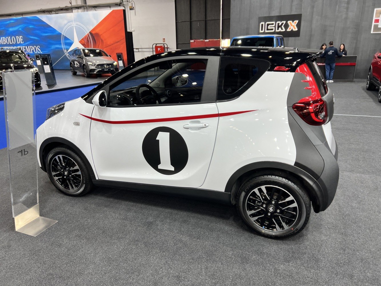 Compact two-tone hatchback with red racing stripe and number 1 decal