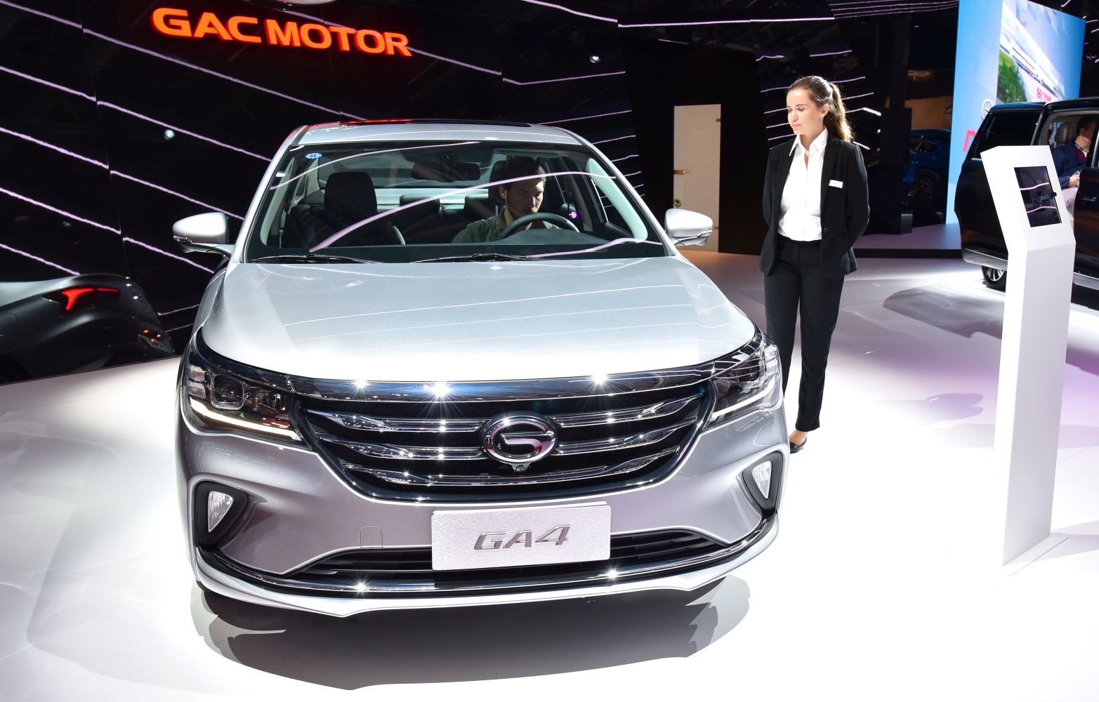 Front view with chrome grille and LED headlights in showroom.