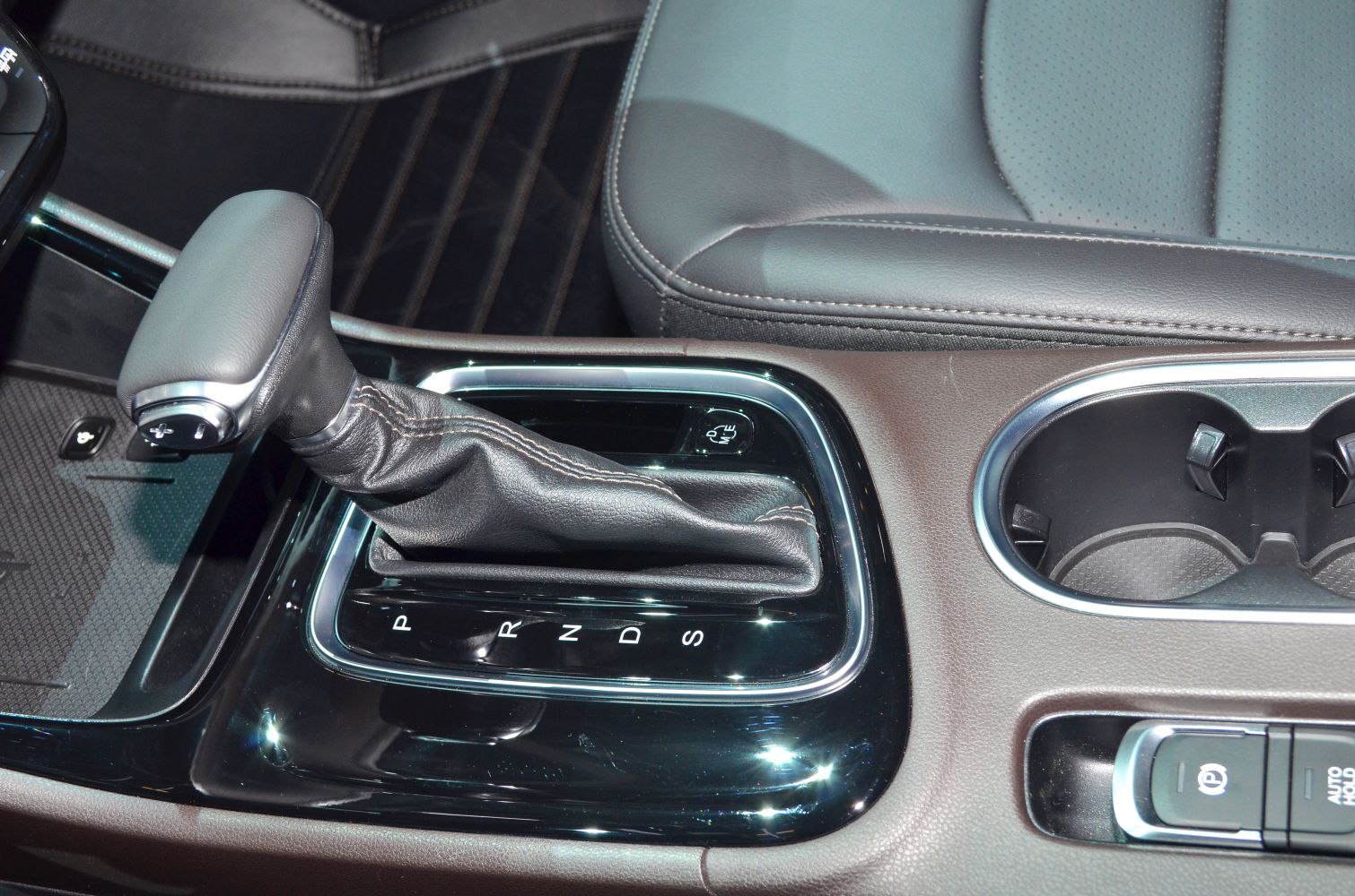 Automatic gear shifter and cup holder in modern car interior